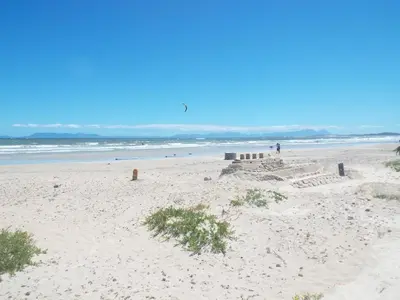 a sand castle on a beach near the ocean at Palmsbeach 3 in Strand