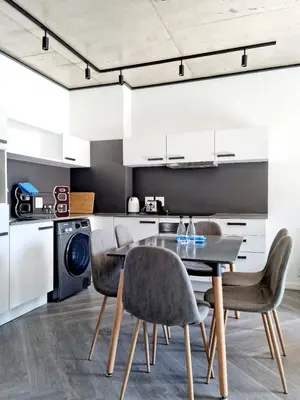a kitchen and dining room with a table and chairs at Bridgewater One by Smart City Stays in Cape Town
