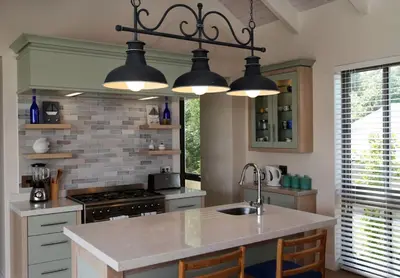 a kitchen with three lights hanging from the ceiling at Knight's House in Hermanus