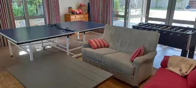 a living room with a ping pong table and a couch at Knight's House in Hermanus