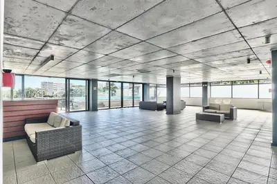 a lobby with couches and chairs in a building at Sea and Sun-Table Mountain views Wifi Parking! in Cape Town