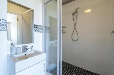 a bathroom with a sink and a shower at Sea and Sun-Table Mountain views Wifi Parking! in Cape Town