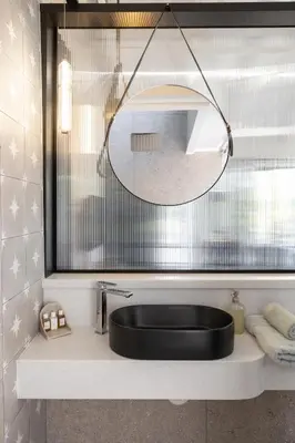 a bathroom with a black sink and a mirror at Hornbill House Self Catering Accommodation in Hermanus