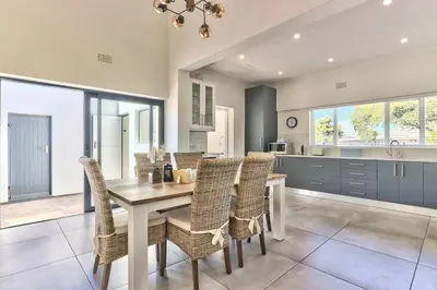 a dining room with a table and chairs in a kitchen at Family Home, WiFi, Patio, Secure Parking in Cape Town