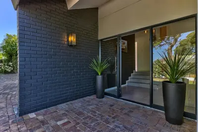 two potted plants on the side of a building at Family Home, WiFi, Patio, Secure Parking in Cape Town