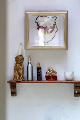a shelf with a picture and other items on it at Art Box in Greyton