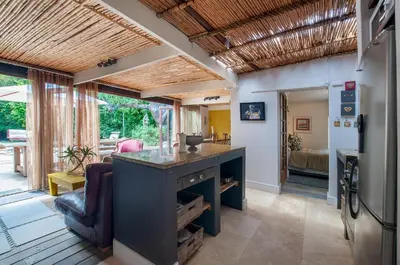 a kitchen and living room with a counter in a room at Art Box in Greyton