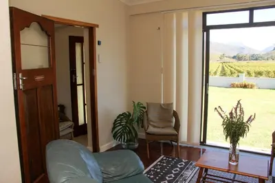 a living room with a couch and a large window at Die Kelderhuis in Breerivier