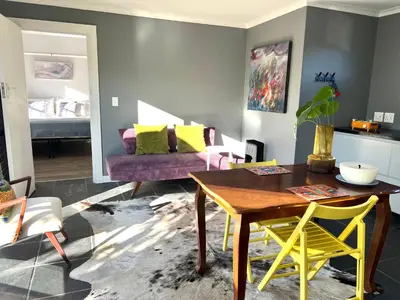 a living room with a table and a couch at Spacious Stays Apartment in Paarl