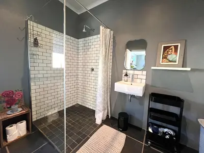 a bathroom with a shower and a sink at Spacious Stays Apartment in Paarl
