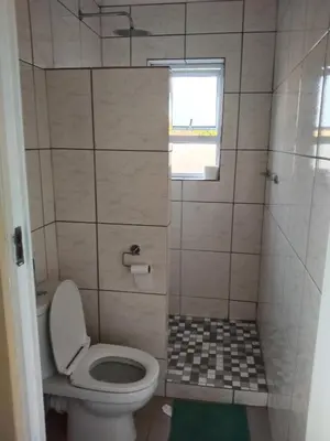 a small bathroom with a toilet and a shower at On the Wrench in Cape Town