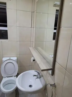 a bathroom with a white toilet and a sink at On the Wrench in Cape Town