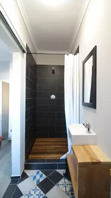 a bathroom with a sink and a shower at Boardrooms Kite Accommodation in Cape Town