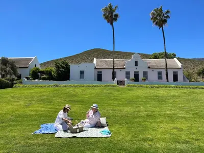 two people sitting on a blanket in the grass at Penhill Farm West Grange in Nuy