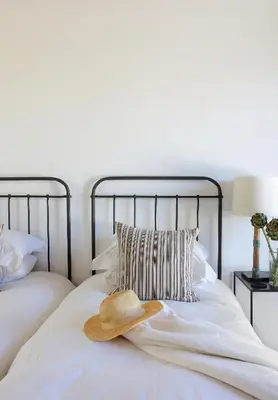 a hat sitting on top of a bed at Penhill Farm East Grange in Nuy