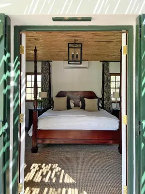 a bedroom with a canopy bed in a house at Penhill Farm Peppertree Cottage in Nuy