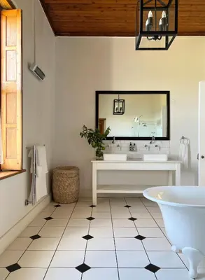 a bathroom with a tub and a sink and a mirror at Penhill Farm The Manor House in Nuy