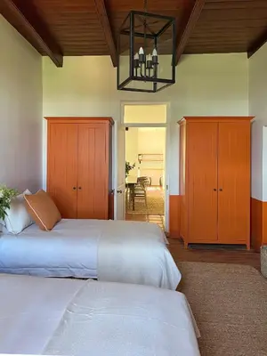 a bedroom with two beds and a chandelier at Penhill Farm The Manor House in Nuy