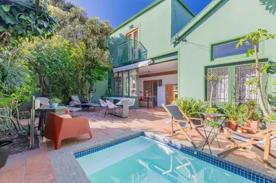 a house with a swimming pool in front of a house at Casa Lucia in Cape Town