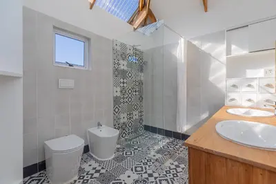 a bathroom with a toilet and a sink at Casa Lucia in Cape Town