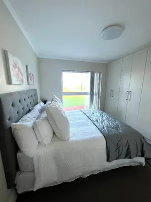 a bedroom with a large bed with a window at Ashton Park 221 in Cape Town