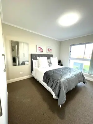 a bedroom with a large bed and a large window at Ashton Park 221 in Cape Town