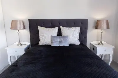 a bedroom with a large bed with two night stands at MLMK Property 17 in Cape Town