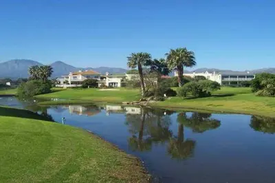 a view of a river with palm trees and houses at Sunset Paradise in Cape Town