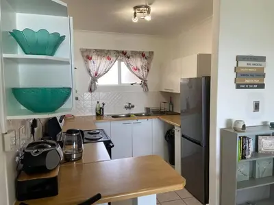 a kitchen with a counter top and a refrigerator at Sunset Paradise in Cape Town