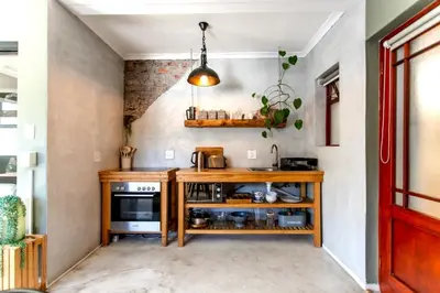 a kitchen with a wooden counter and a stove at Oak on Main in Hermanus