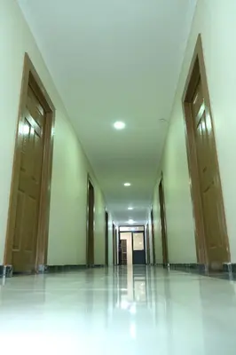 an empty hallway of a building with wooden doors at Supa Guesthouse in Parow