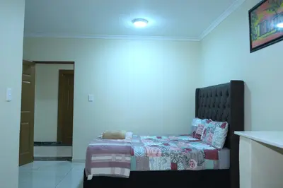 a bedroom with a bed in a blue room at Supa Guesthouse in Parow