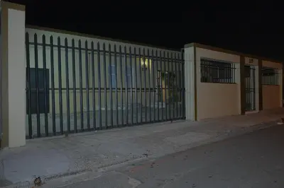a gate in front of a building at night at Supa Guesthouse in Parow