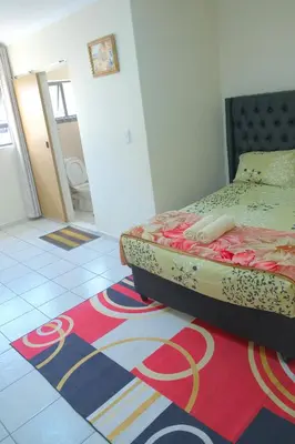 a bedroom with a bed and a rug on the floor at Supa Guesthouse in Parow