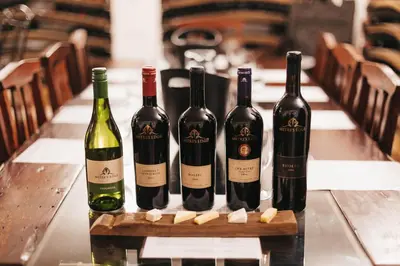 four bottles of wine sitting on a table at Mitre's Edge Pool House in Klapmuts