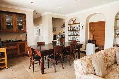 a kitchen and dining room with a table and chairs at Mitre's Edge Pool House in Klapmuts