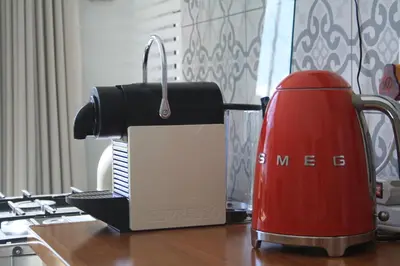 a red toaster sitting on top of a table at Tortelduif Cottage in Stellenbosch