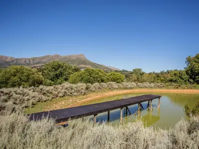 a house on a lake with a dock at Wechmarshof in Stellenbosch