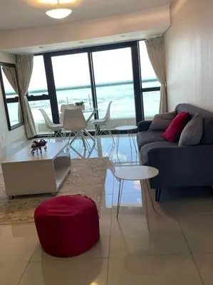 a living room with a couch and a table at Beautiful Ocean View Apartment in Cape Town