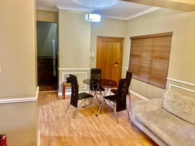 a living room with a table and a couch at Beautiful apartment in century city in Cape Town