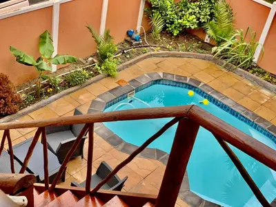 a small swimming pool in the middle of a building at Beautiful apartment in century city in Cape Town