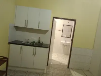 a kitchen with a sink and a toilet in a room at Jacmo Guest house in Cape Town