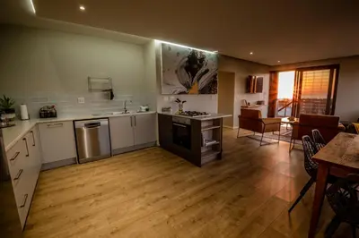a kitchen with a sink and a stove top oven at Escape to Pringle in Pringle Bay