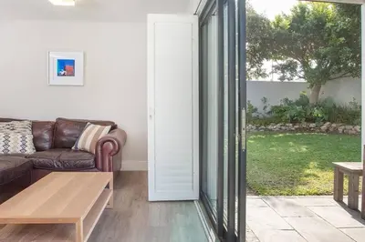 a living room with a couch and a table at Kingklip by Top Destinations Rentals in Hermanus