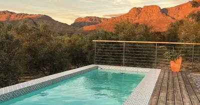 a swimming pool with a view of the mountains at Bains View Olive and Guest Farm in Wellington