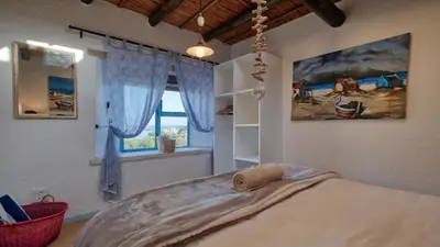 a bedroom with a bed and a window at Rox Villa in Rooiels