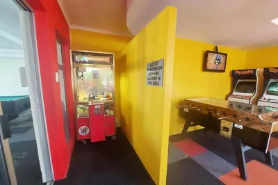 a room with a yellow and red wall at First Group Hermanus Beach Club in Hermanus