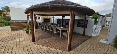 a gazebo with a table and chairs on a patio at Villa Venusta Luxury Guesthouse - Solar Power in Hermanus
