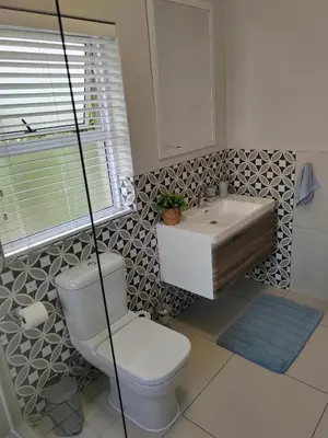a bathroom with a toilet and a sink at Leafy Retreat Kenridge in Durbanville