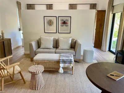a living room with a couch and a table at Mountain Cottages at Haskell Vineyard in Stellenbosch